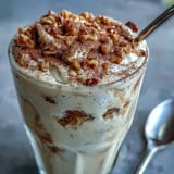 Rich Hojicha milkshake blending roasted green tea with vanilla ice cream, dusted with hojicha powder.