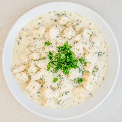 Creamy Garlic Chicken Bites simmered in a cheesy garlic sauce, served steaming hot alongside fluffy white rice.