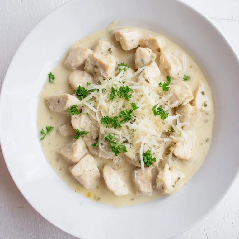 Tender Creamy Garlic Chicken Bites in a velvety sauce, garnished with fresh parsley and ready to serve.