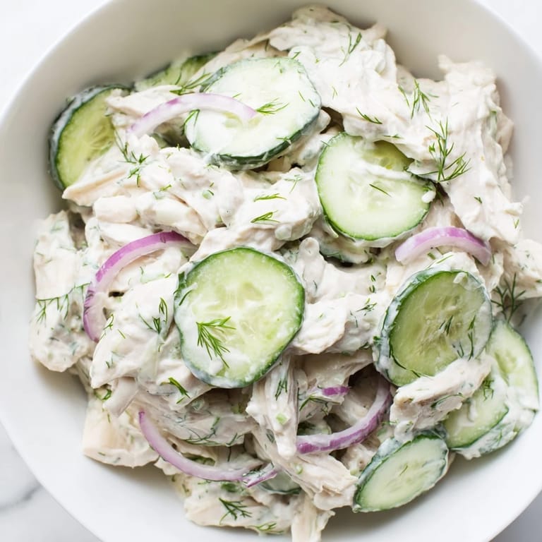 A refreshing Creamy Cucumber Chicken Salad garnished with fresh dill and green onions, perfect for a light lunch.  