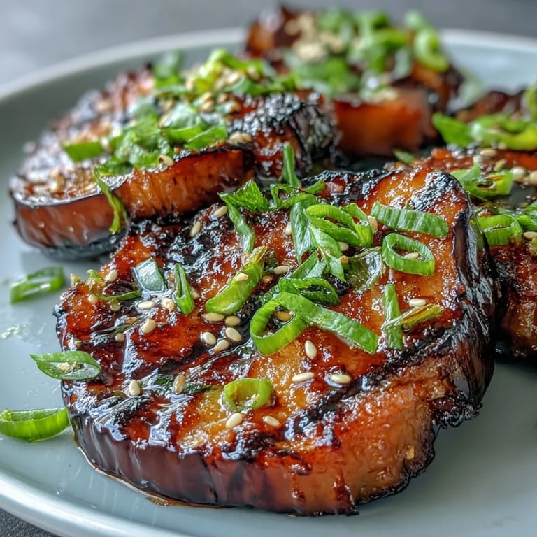 Beautifully broiled Miso Glazed Eggplant, topped with sesame seeds and green onions.