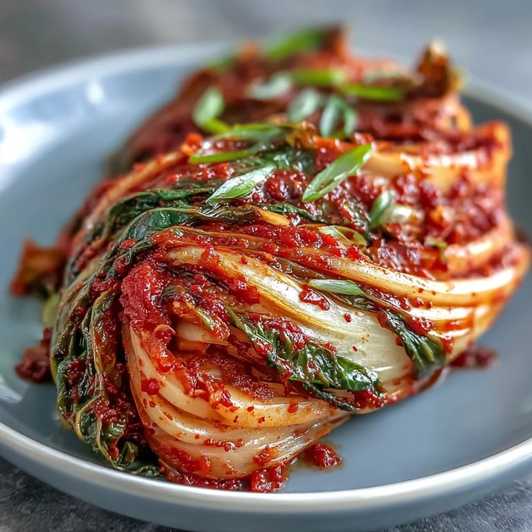 Freshly made kimchi glistening, ready to add tangy crunch to your plate.